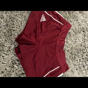 Adidas maroon with grey stripe shorts.
